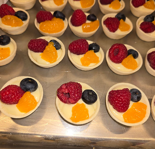 parfait with yogurt, blueberry, strawberry and peach catered by A Catered Affair