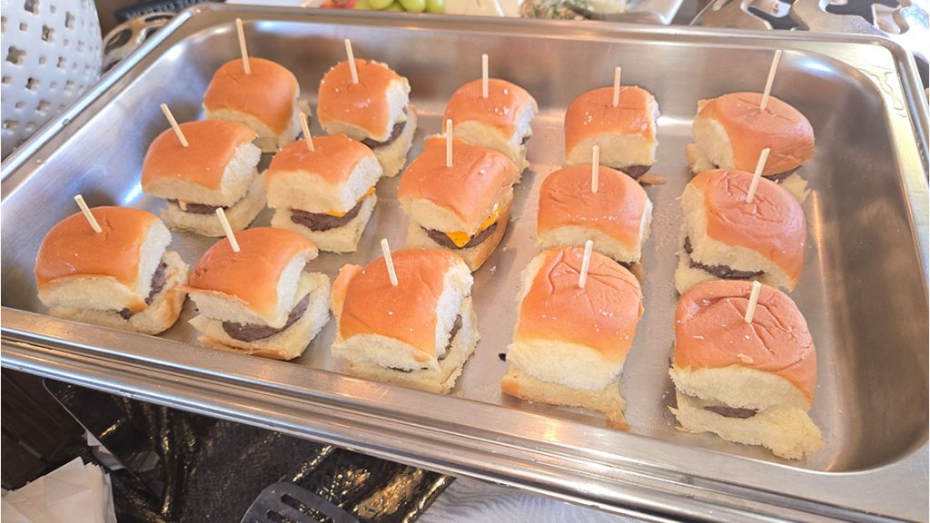cheeseburger sliders in a metal food container catered by A Catered Affair